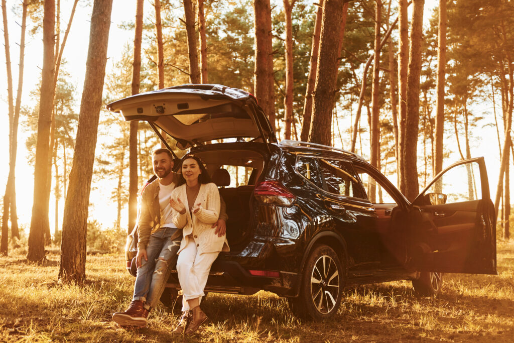 Happy couple enjoying a car rental in albania.