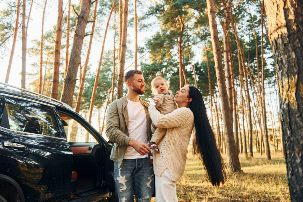 Family of father, mother and little daughter enjoying a car rental in albania